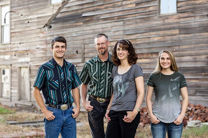 Kelli posing with her family, all smiling