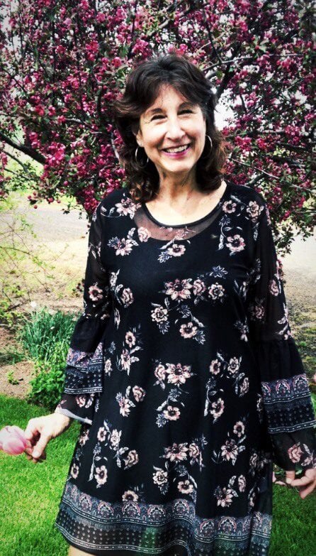 Lori smiling in a park
